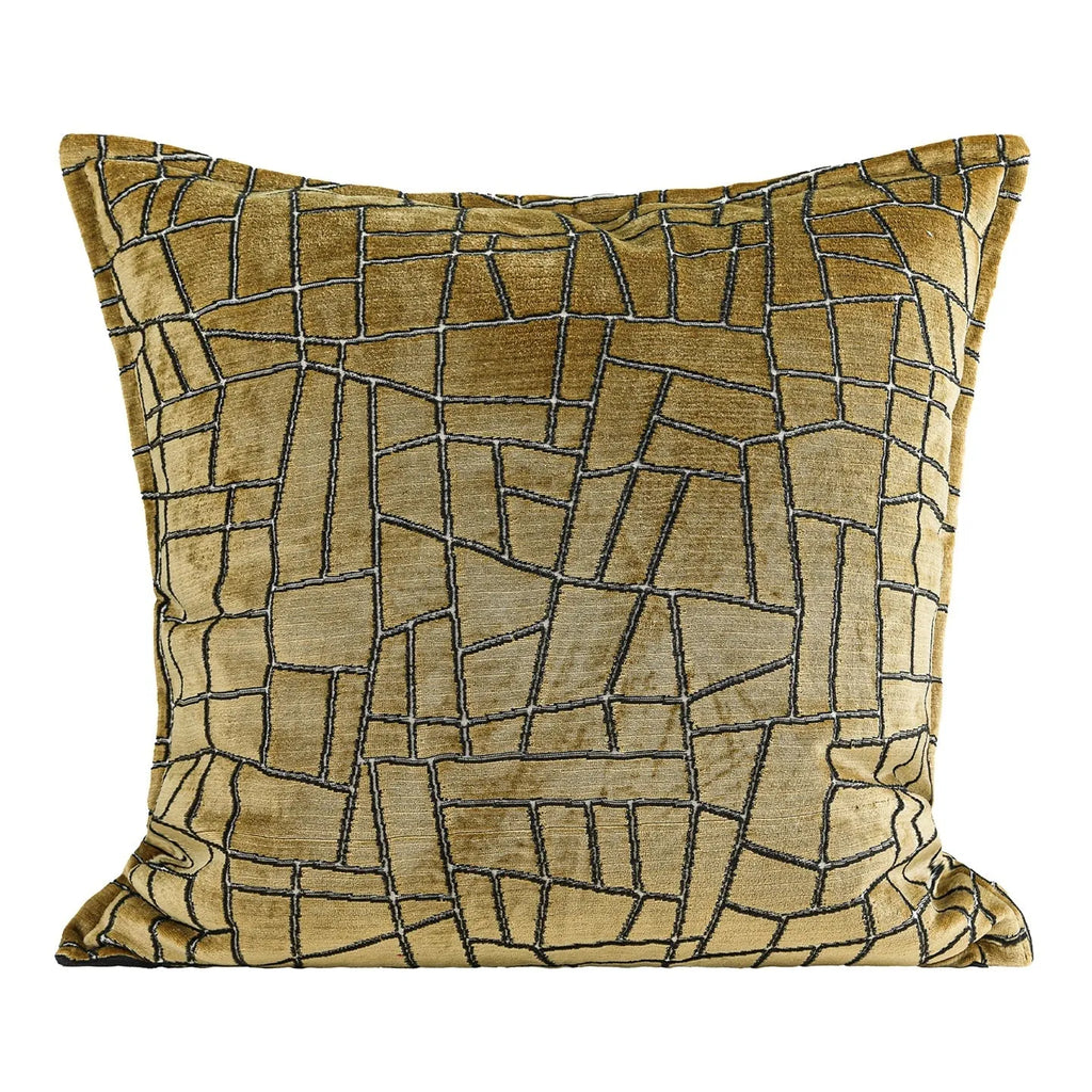 Gold geometric pattern decorative cushion cover on a grey sofa