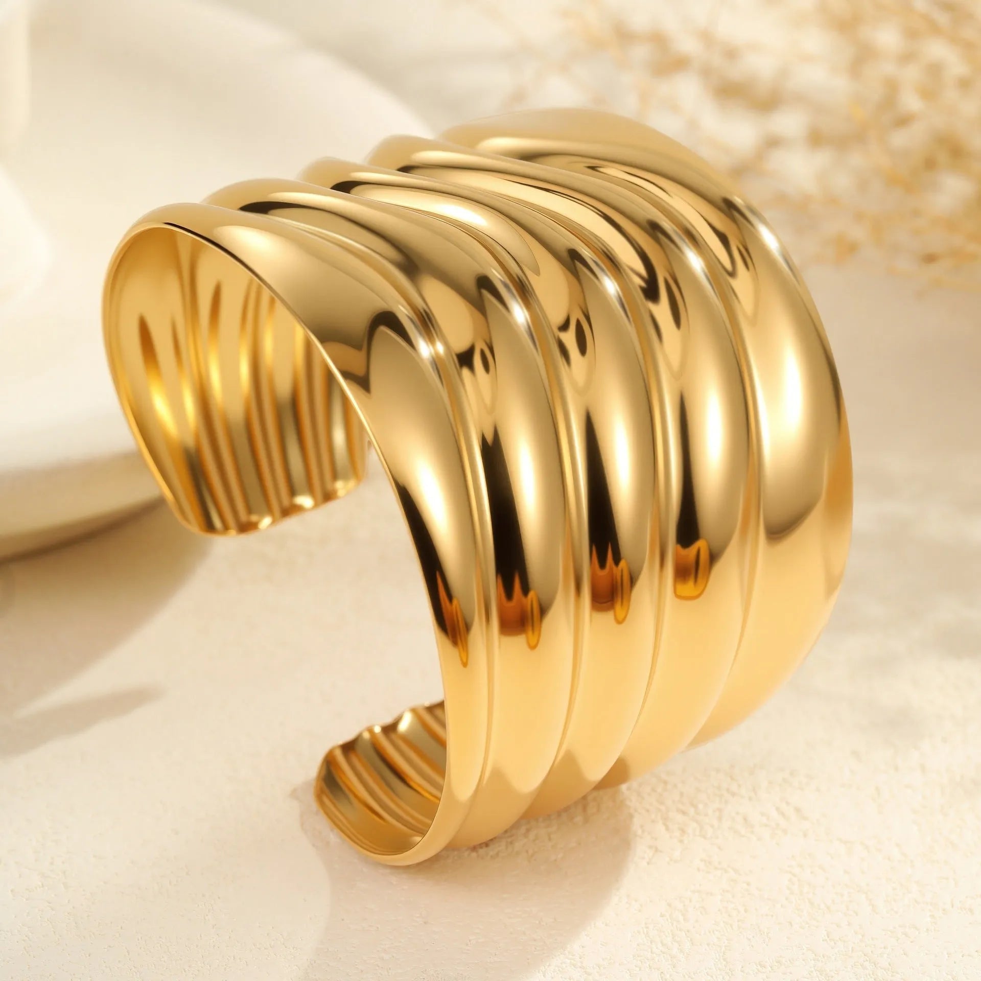 Women's wide stainless steel bracelet with gold plating and niche opening design