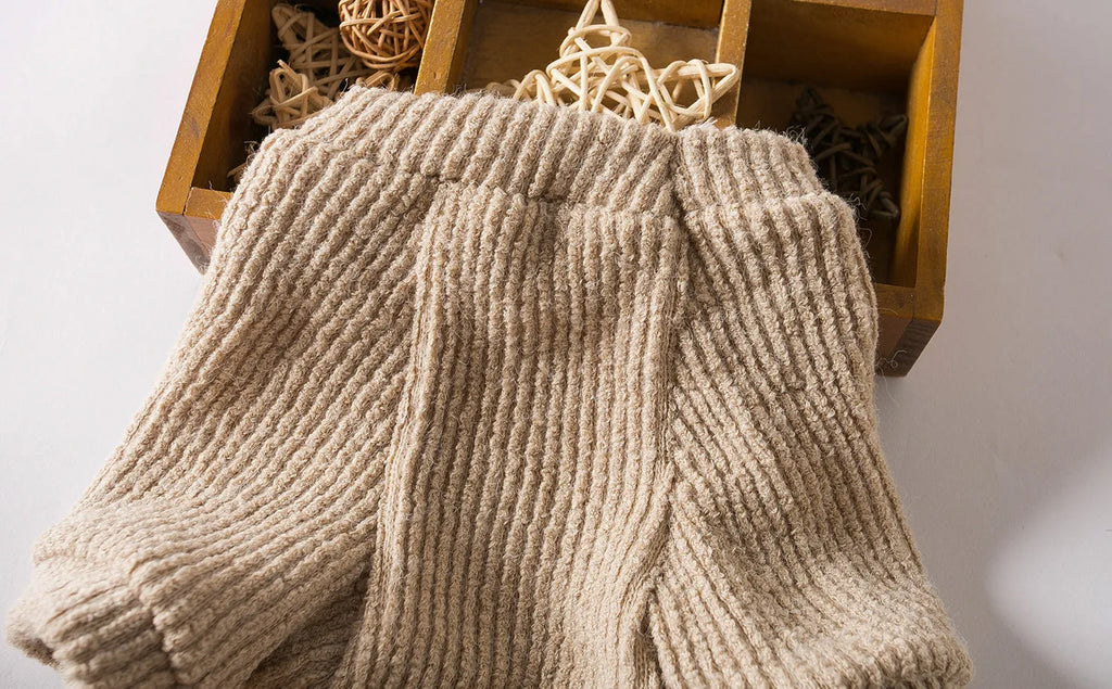 Brown cloth pullover sweater for small breed dogs on a Bichon Frise