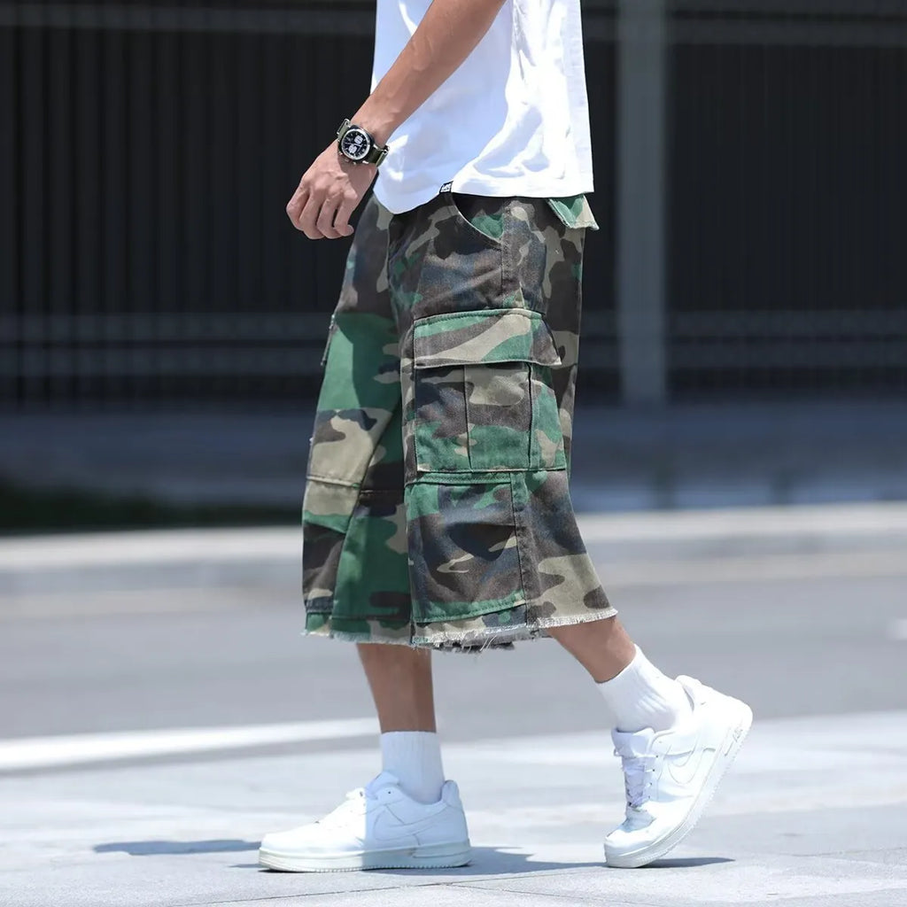 Man's loose-fit cotton shorts in a camouflage print with a cropped length and retro workwear style.