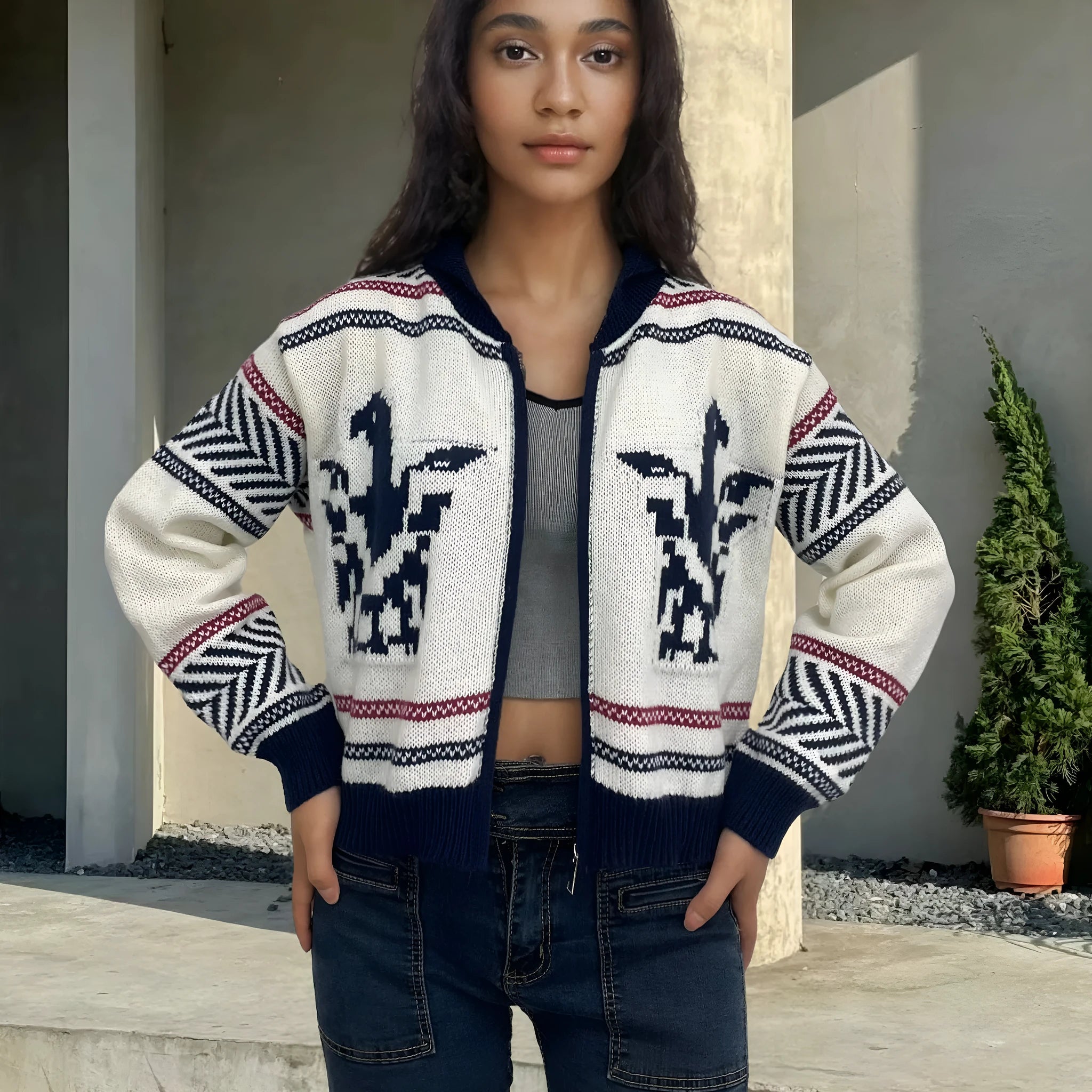 White women's cardigan with front zip, lapel collar, and jacquard contrast stripe pattern.
