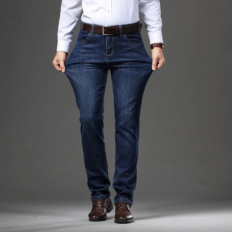 Man wearing straight-leg black stretch denim jeans with a mid waist and zip fly.