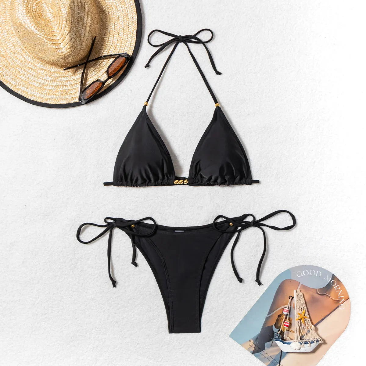 Black women's bikini swimsuit with metal bead decoration and split leg design