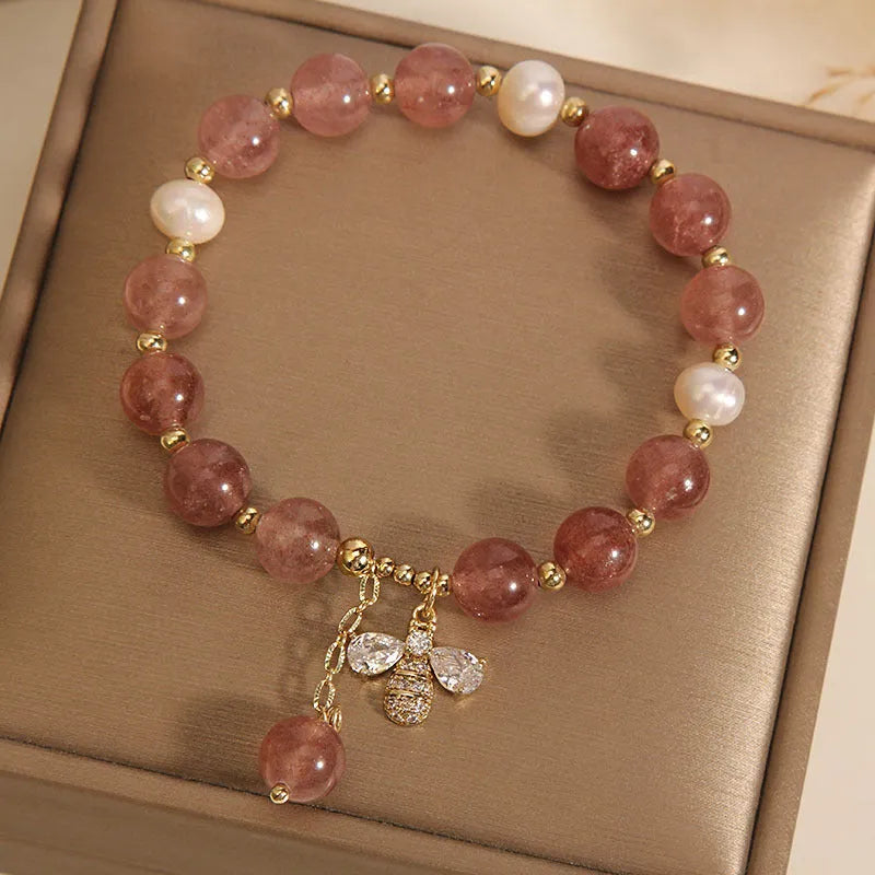 Freshwater pearl and strawberry quartz bracelet with zircon accents on wrist