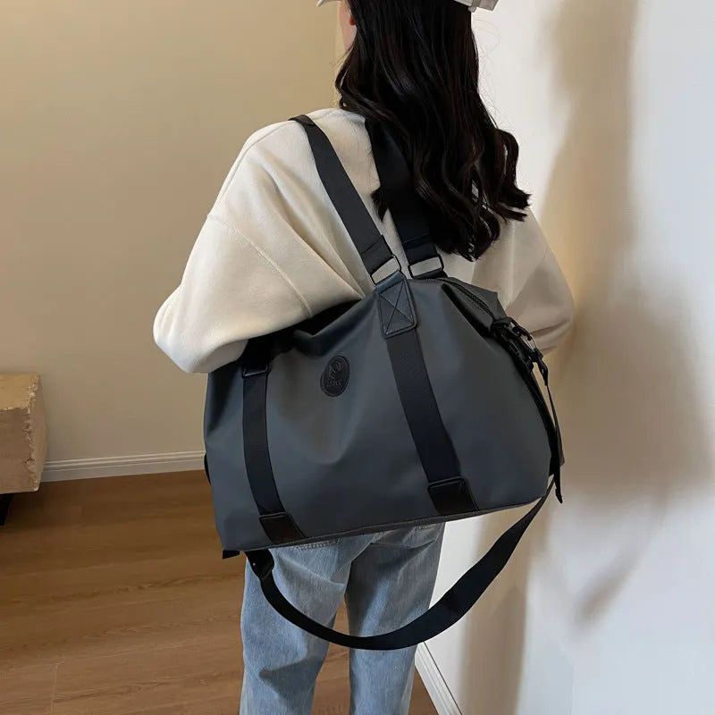 Large black waterproof travel backpack with multiple compartments shown opened to display interior organisation