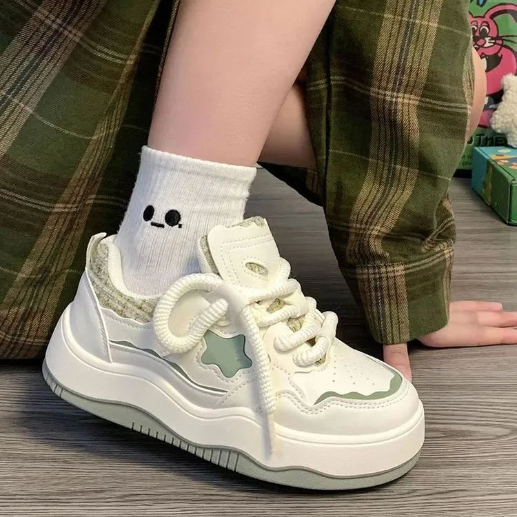 Women's green patent leather platform sneakers with round toe and lace-up front