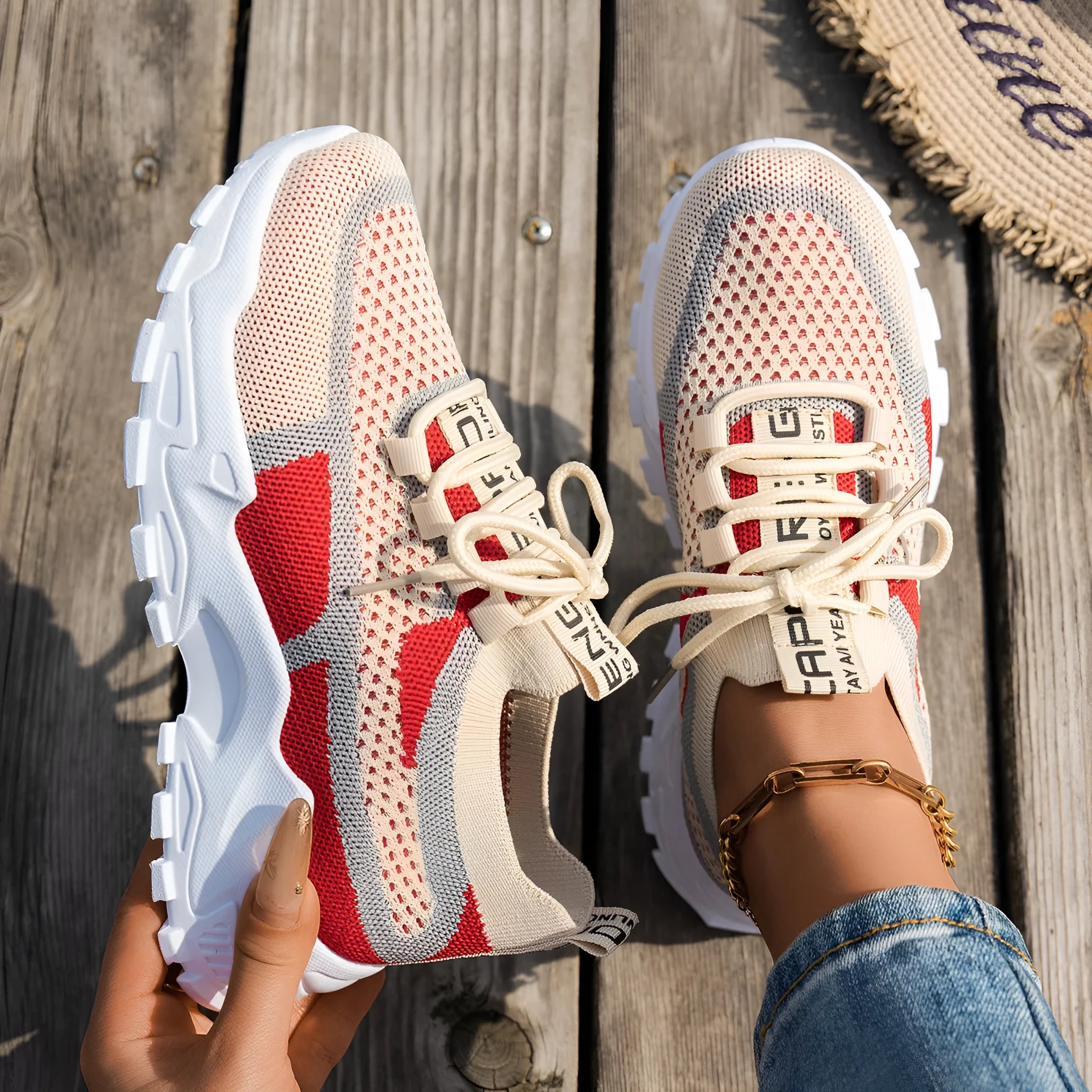 Women's low heel Flyknit mesh sneakers in a grey colour scheme with lace-up front.