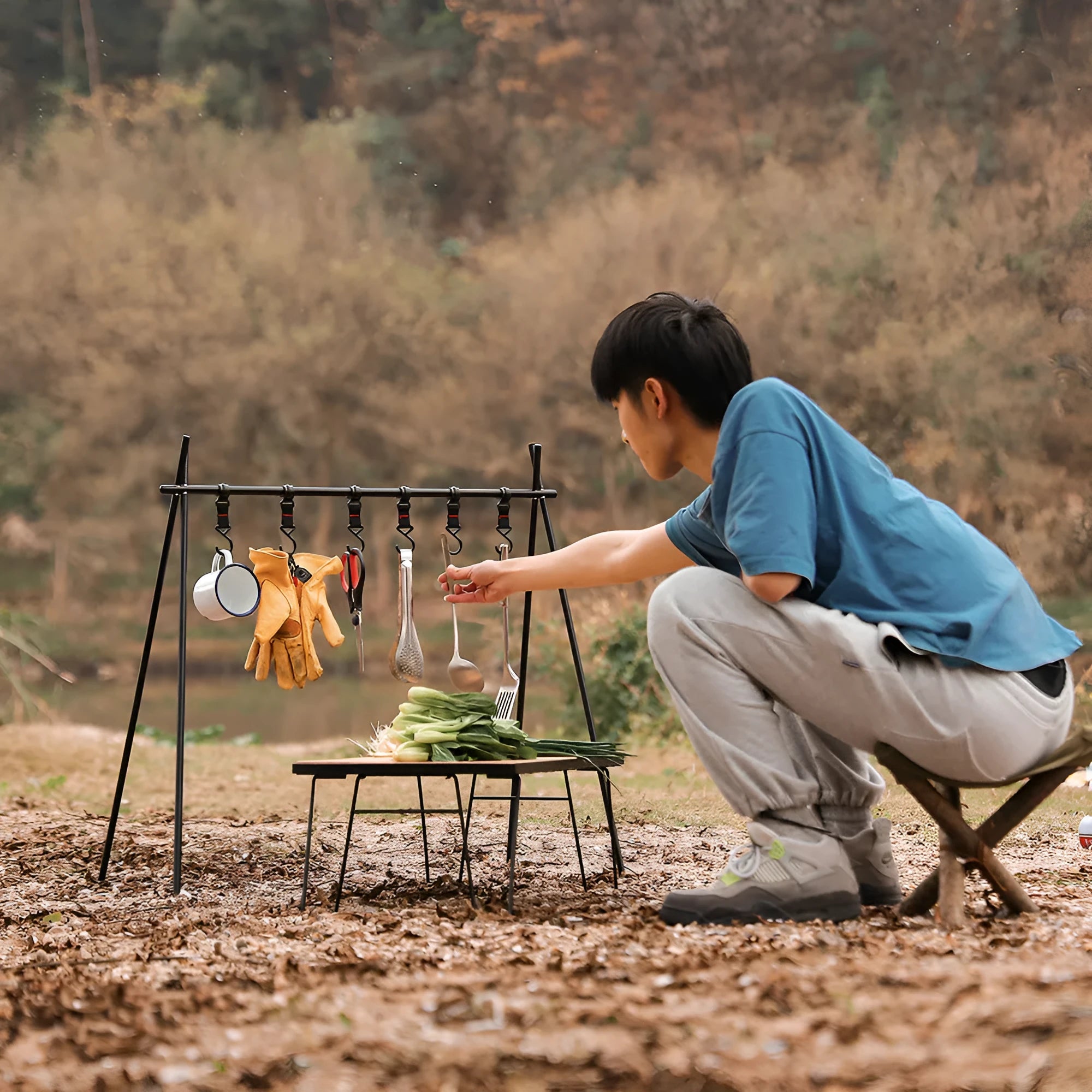 Large foldable aluminium alloy triangle clothes drying rack for camping with side hooks.
