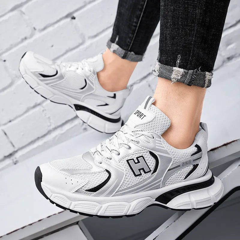 Men's black and white mesh casual running shoes with a round toe and plastic sole.