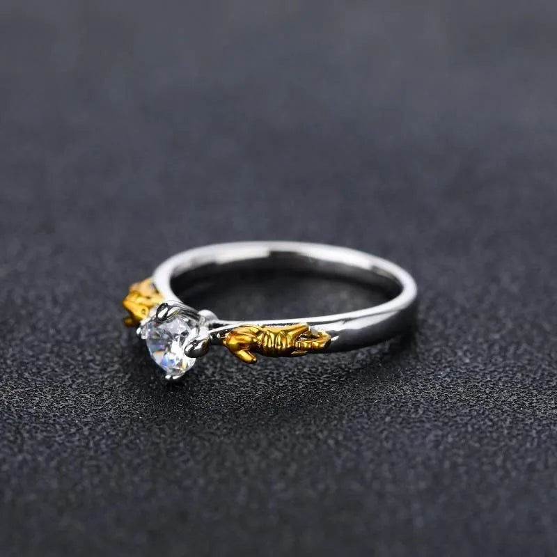 Copper crown cosplay ring with black gold finish and crystal details on a hand.