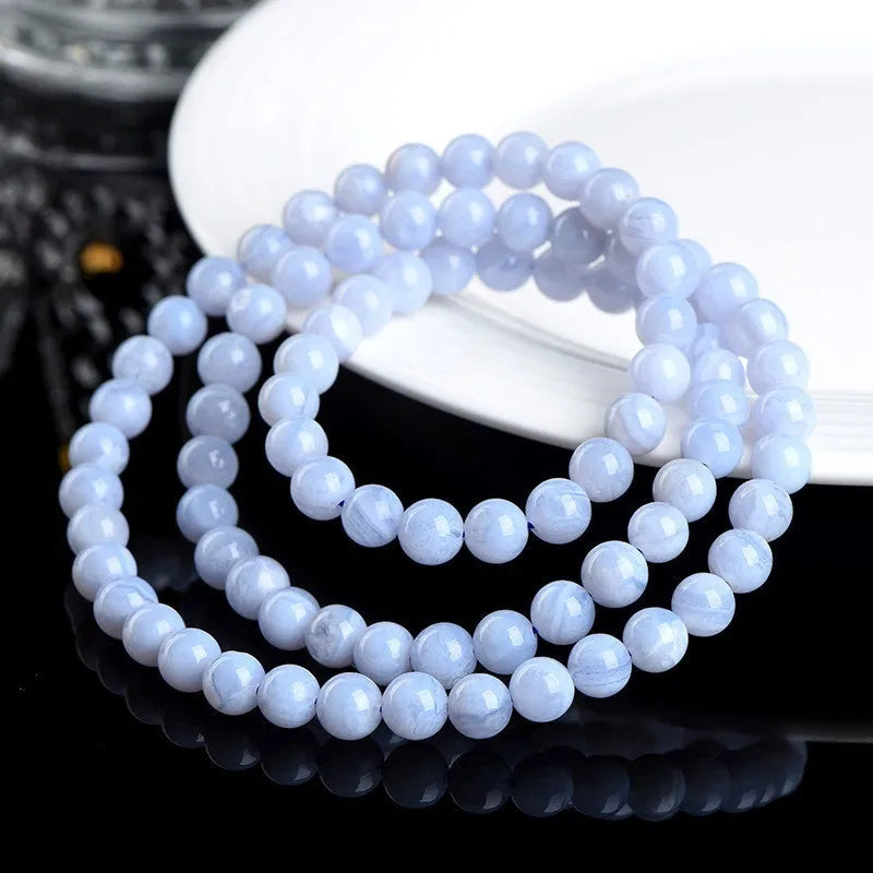 Blue agate bracelet with patterned ball and striped scattered beads showing three-circle construction