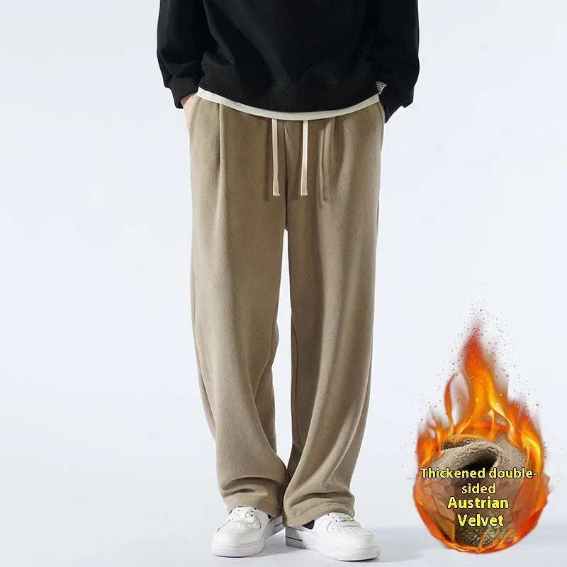 Men's double-sided polar fleece winter sports trousers in apricot colour, showing loose fit and drawstring waistband.