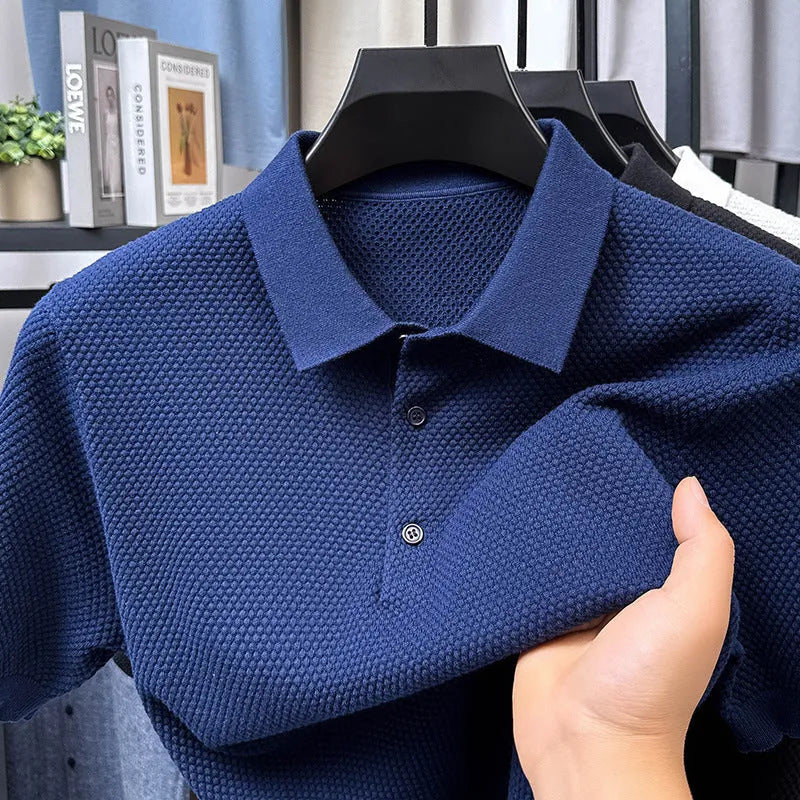 Man wearing a loose-fit grey short sleeve cotton pullover sweater for casual leisure wear.