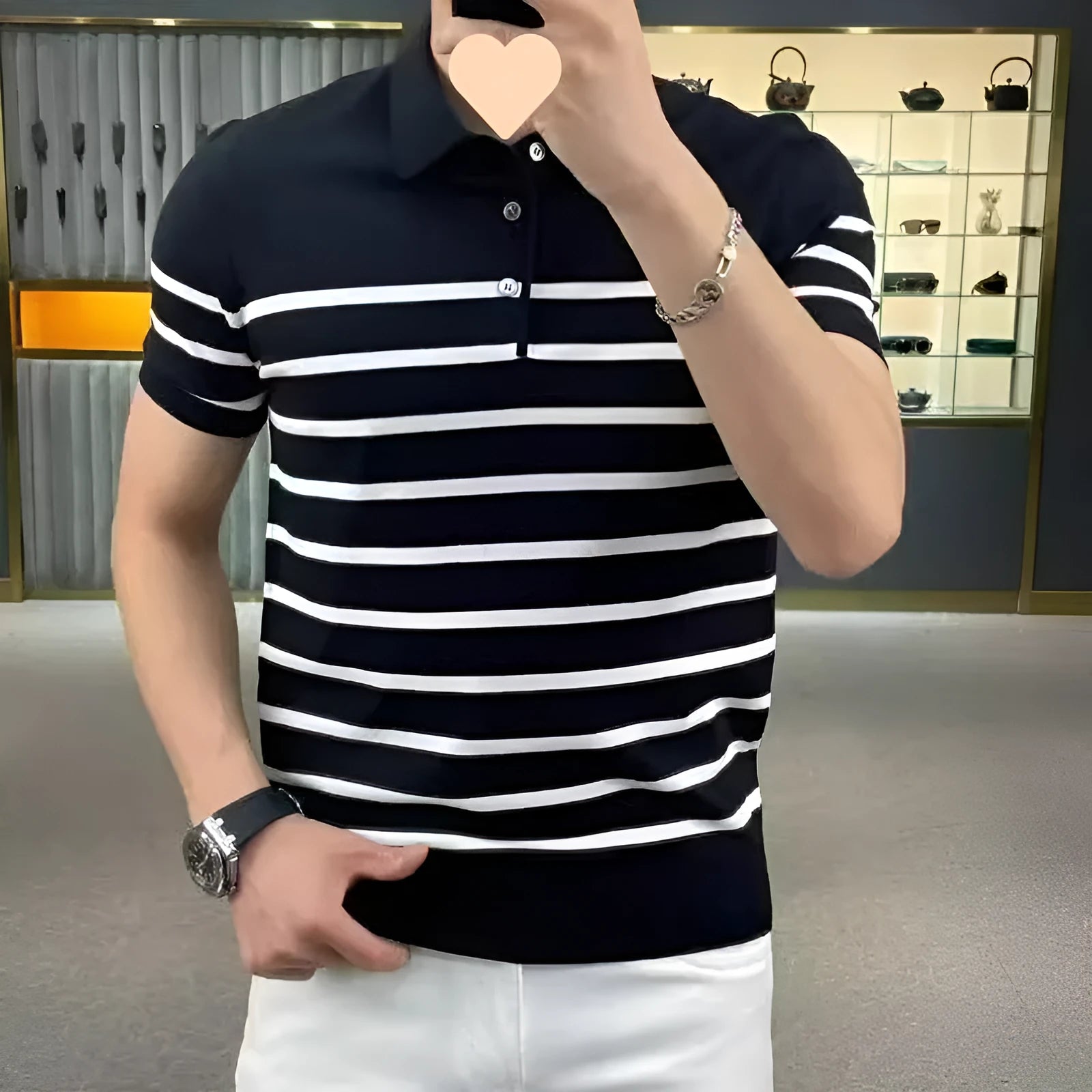 Black and white striped men's knitted T-shirt with a lapel collar, laid flat.