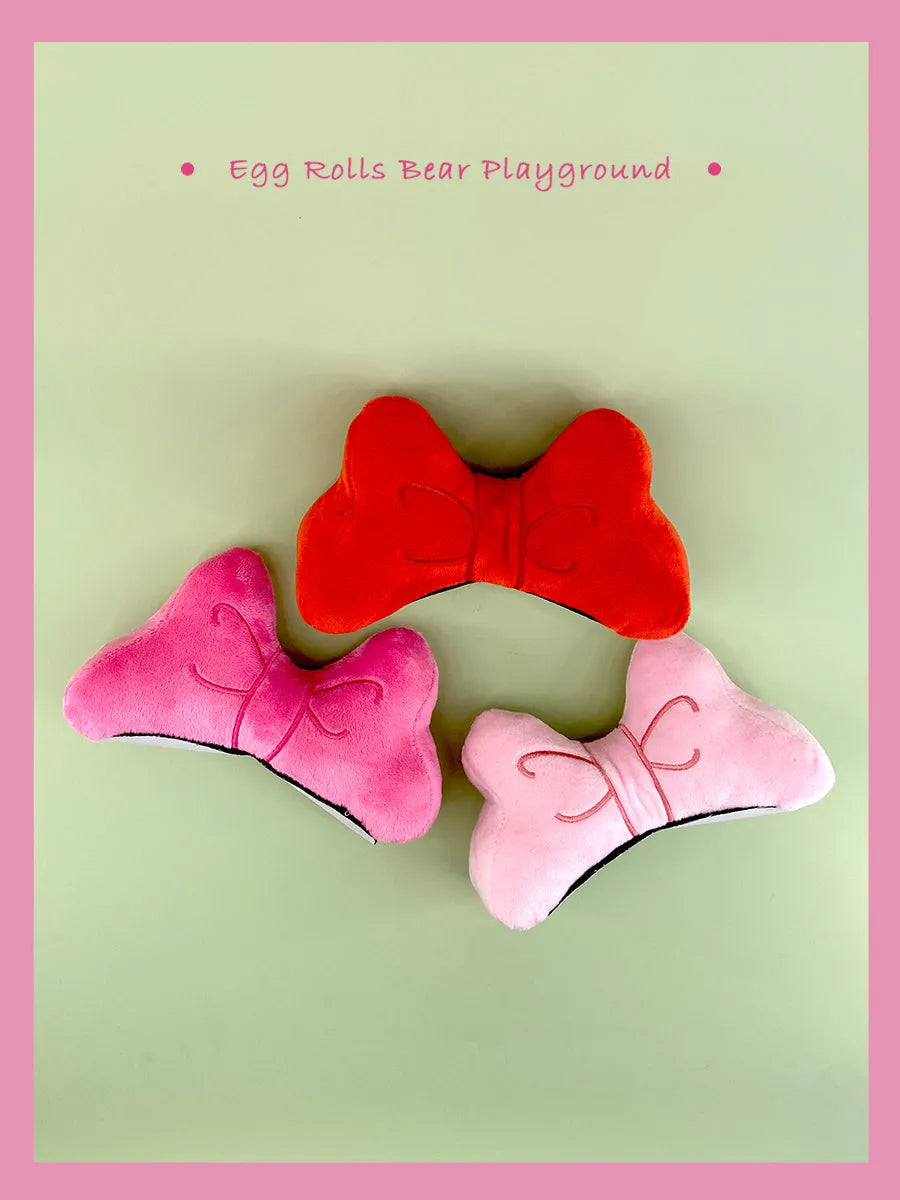 Soft plush bow tie decoration for motorcycle and ski helmets in red, peach pink, or rose pink
