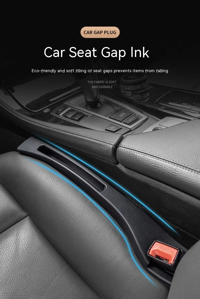 Black plastic car seat gap storage box with handle positioned between vehicle seats