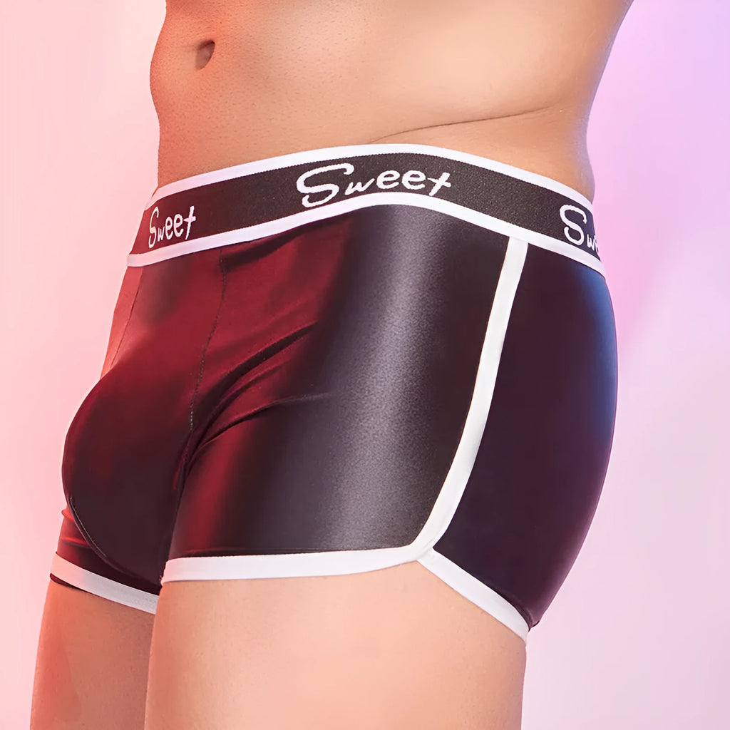 Men's silky nylon boxers in black, white, and sapphire blue colours on a plain background