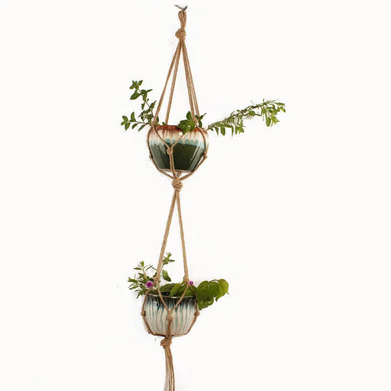 Woven cotton rope wire basket plant pot holder in a wall hanging style.