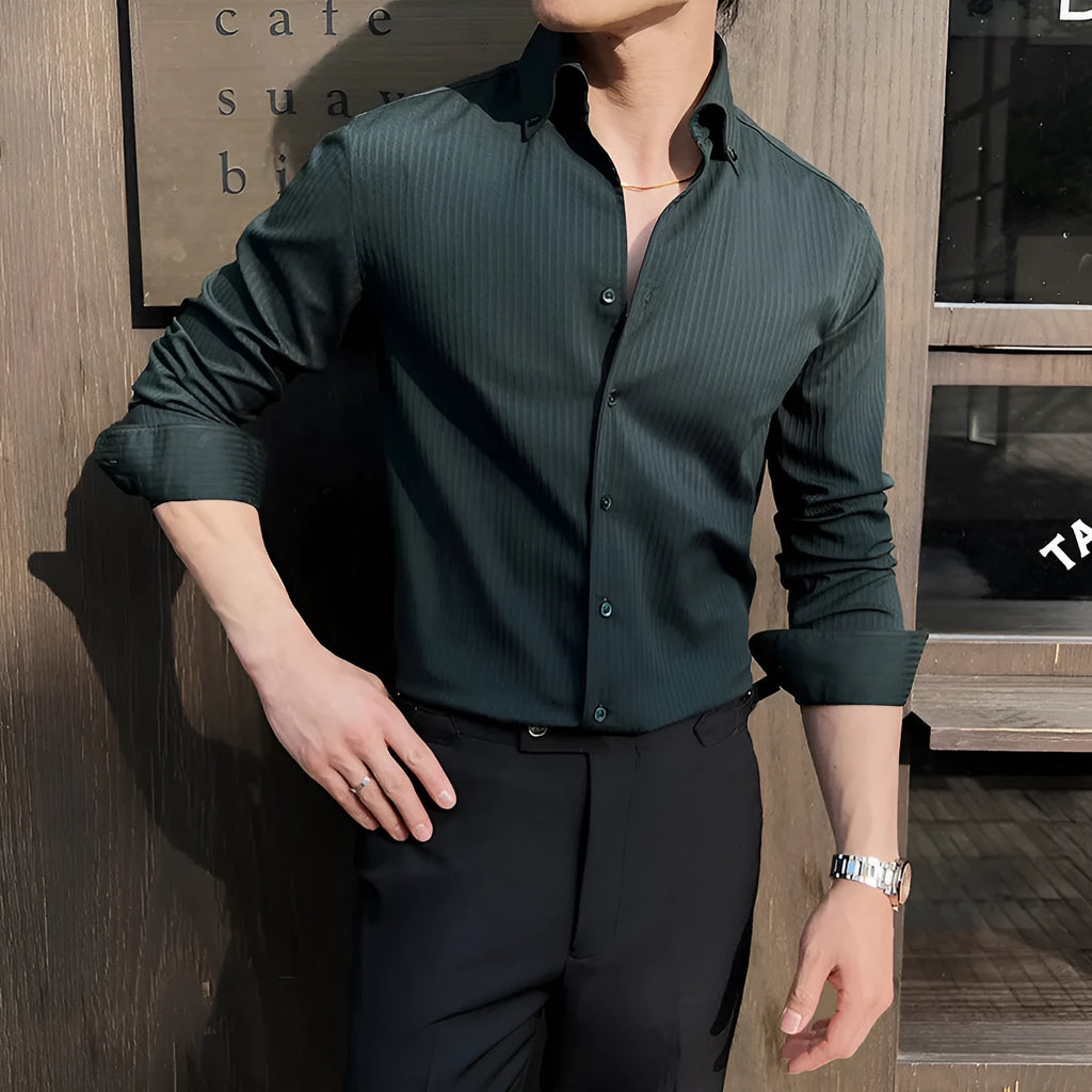Man wearing a dark striped long sleeve V-neck cardigan shirt in a casual setting.