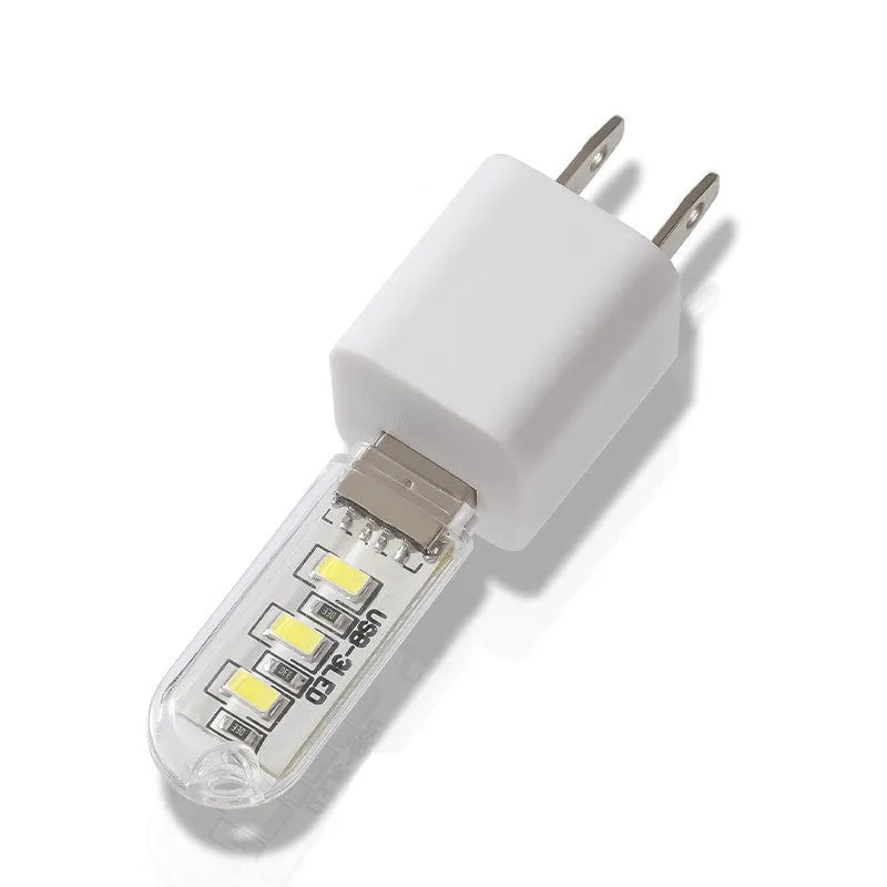 Small white LED night light with USB cable showing compact 6cm bedside design