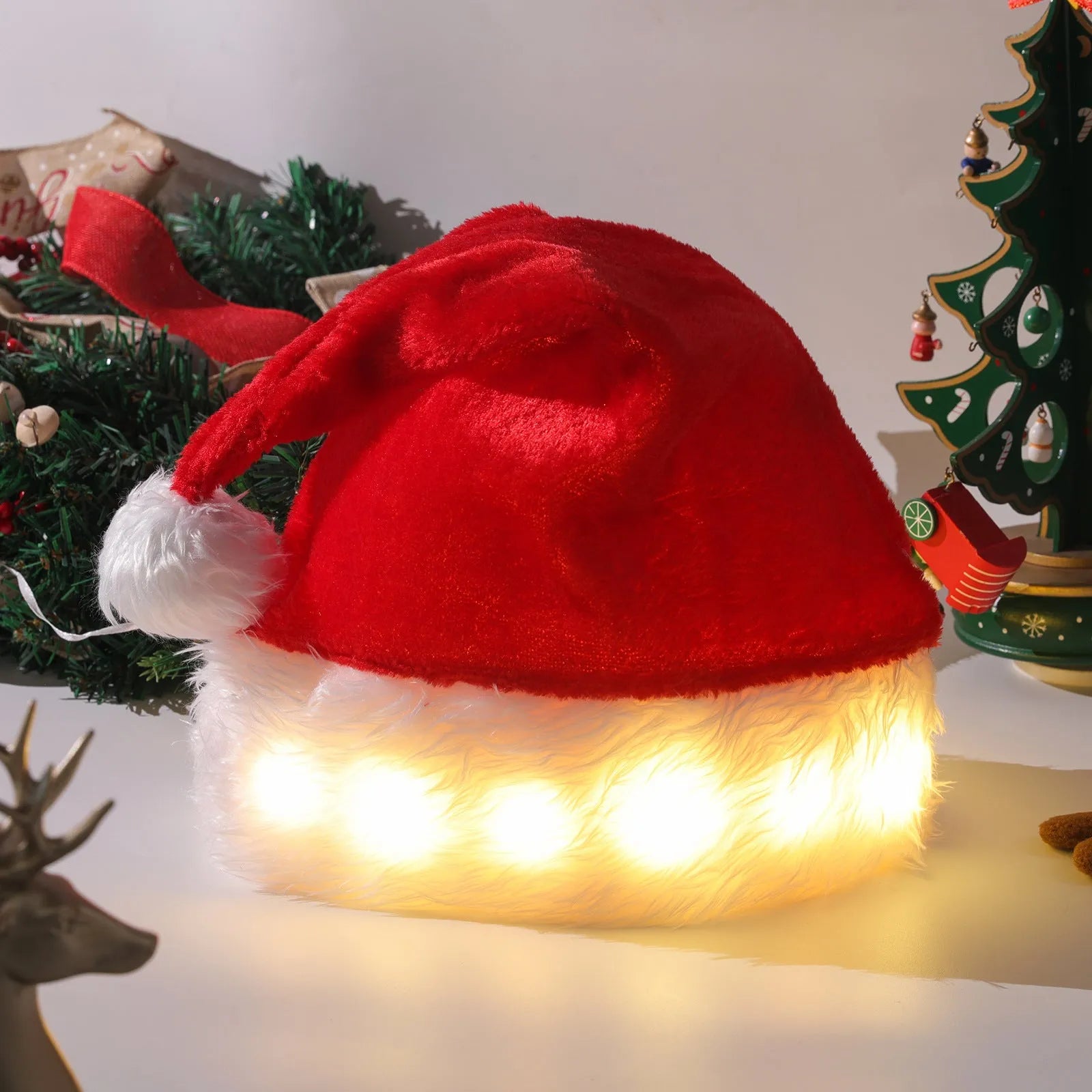 Red and white plush Santa hat with pom-pom and twinkling multi-coloured LED lights around the brim.