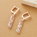 A pair of geometric hollow two-tone stud earrings with a rectangular shape and electroplated alloy finish.