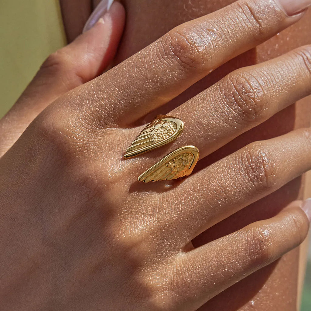 Adjustable stainless steel ring with a winged design in an electroplated silver finish.