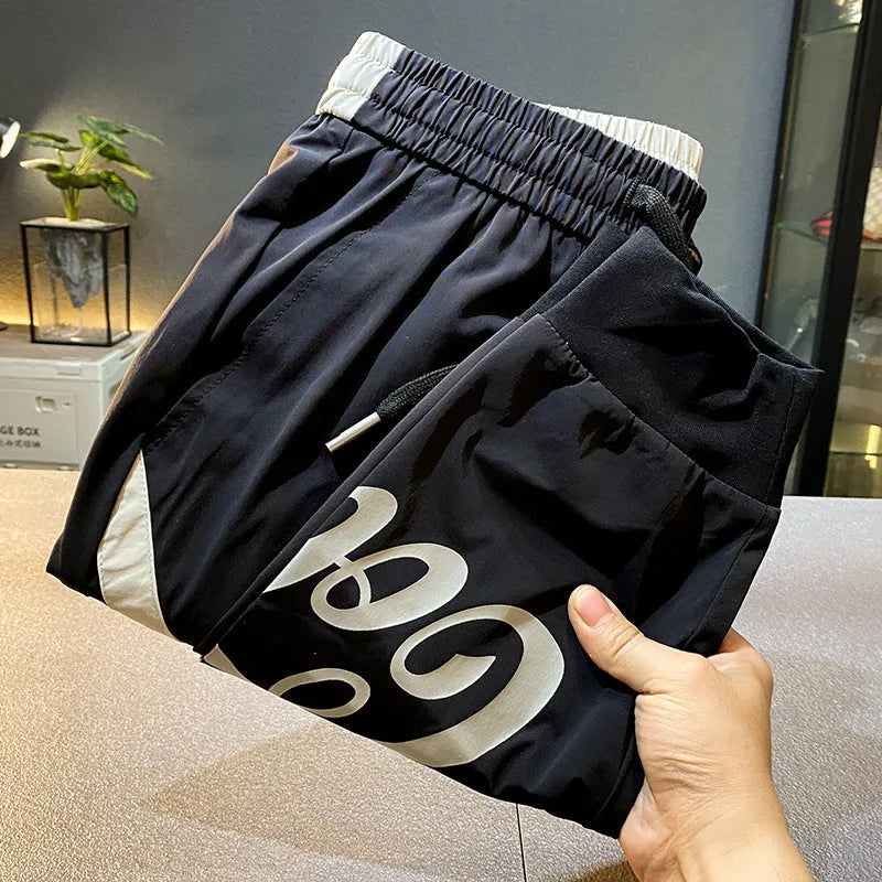 Black men's cropped casual trousers with an ankle band, made from ultra-thin cotton fabric.