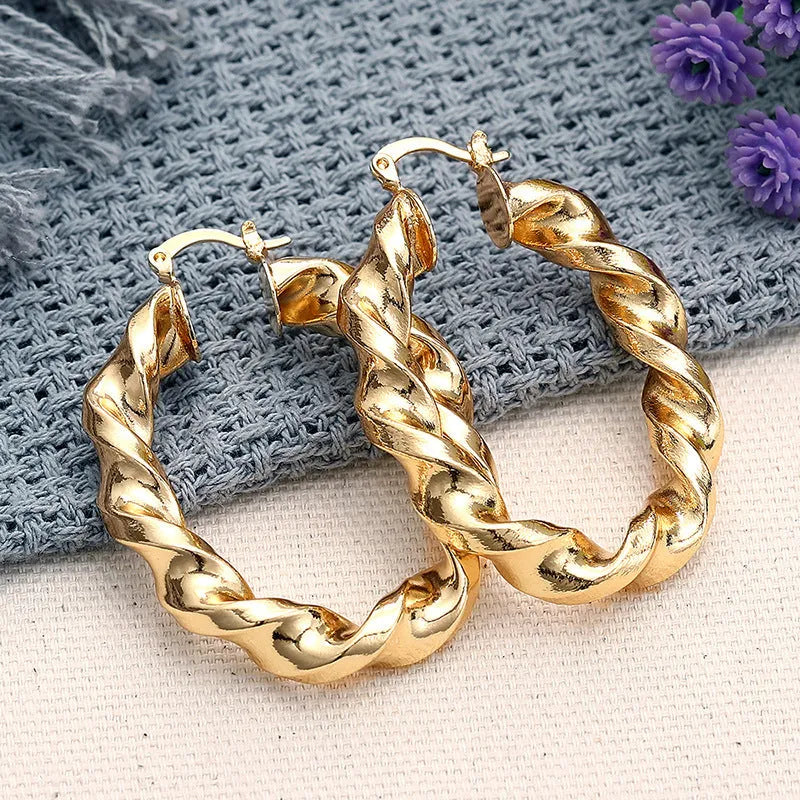Geometric copper ear clip earrings with ring design detail and electroplated finish