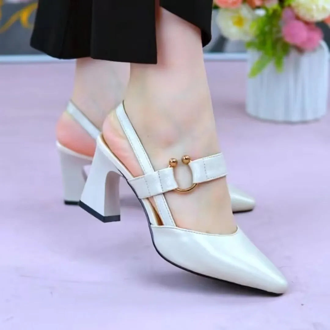 Women's apricot coloured closed toe leather sandals with a chunky rubber heel on a white background.