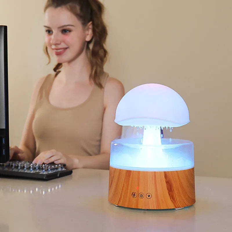 White cloud-shaped ultrasonic humidifier and aroma diffuser with simulated rain drops and coloured light.