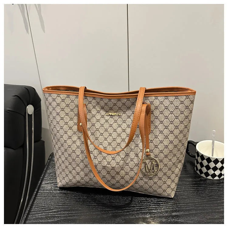 Structured black PU leather shoulder bag with adjustable strap and visible sewing thread detailing