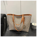 Structured black PU leather shoulder bag with adjustable strap and visible sewing thread detailing