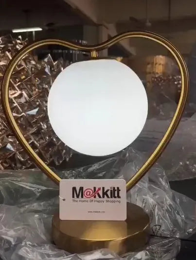 Heart shaped warm white LED decorative lamp on table with UK plug