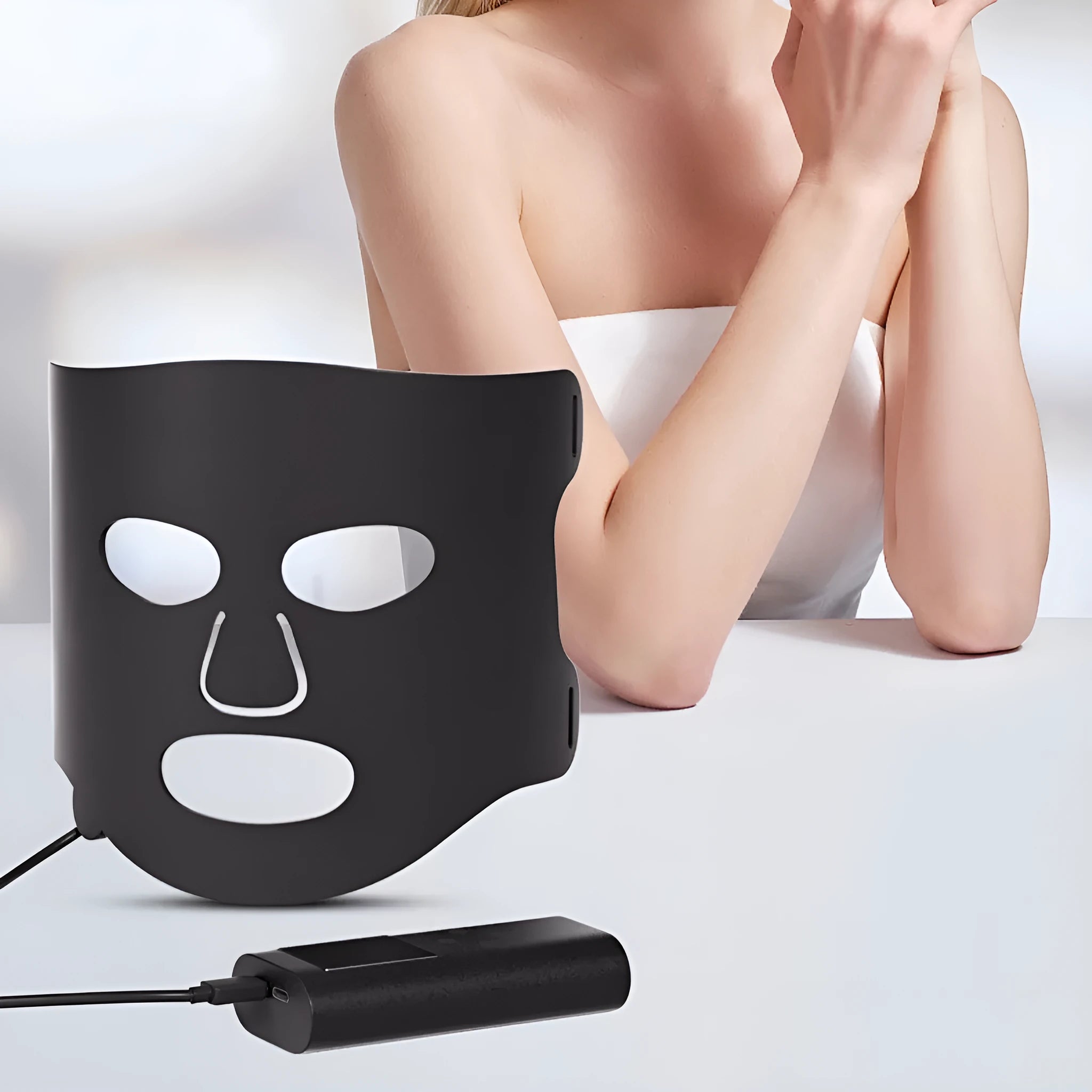 Black and white LED phototherapy face mask with controller showing seven colour light modes
