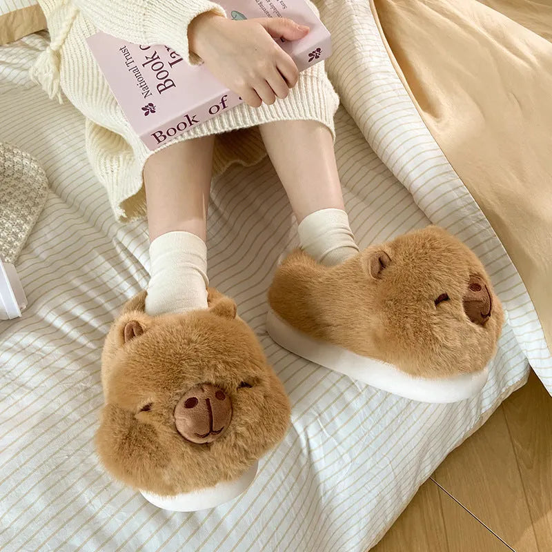 Light brown women's winter slippers with cotton plush upper and cartoon pattern.