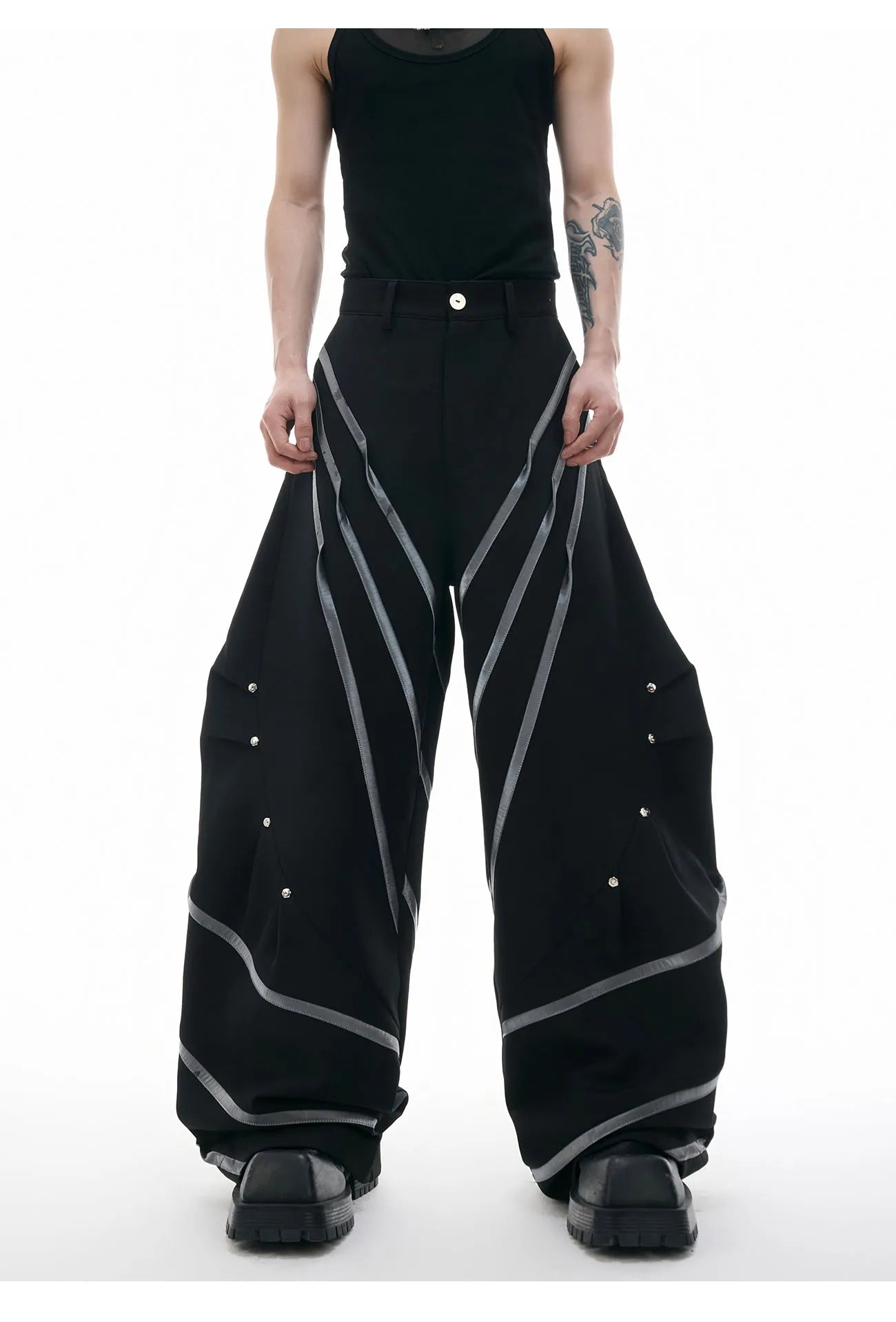 Men's grey polyester trousers with metal rivet stripes, front pleats, and a 3D cut, shown in sizes S to XL.