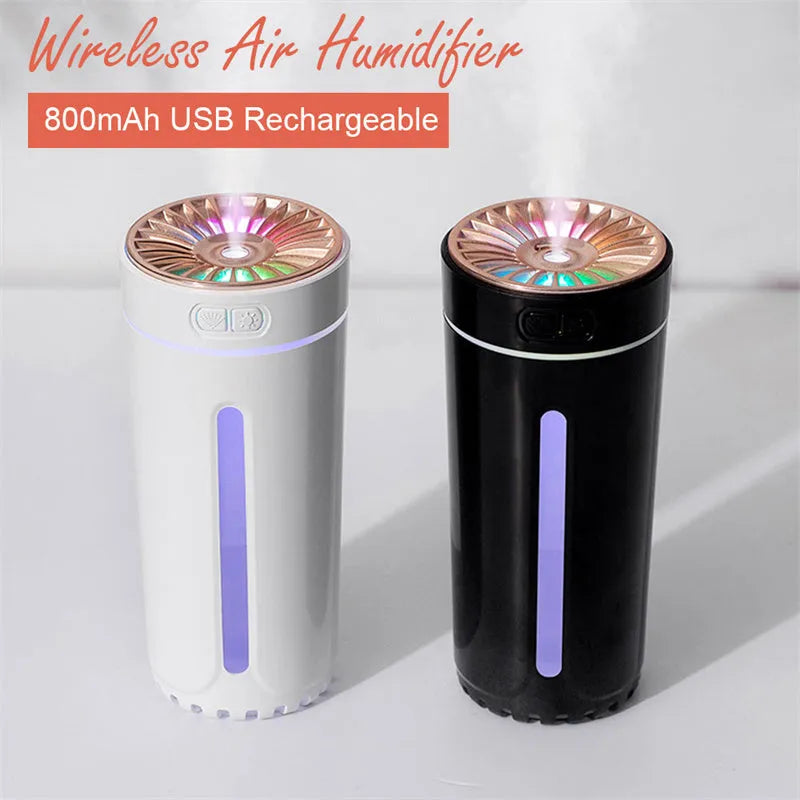 Black portable wireless ultrasonic humidifier with colourful LED lights on a car cup holder.