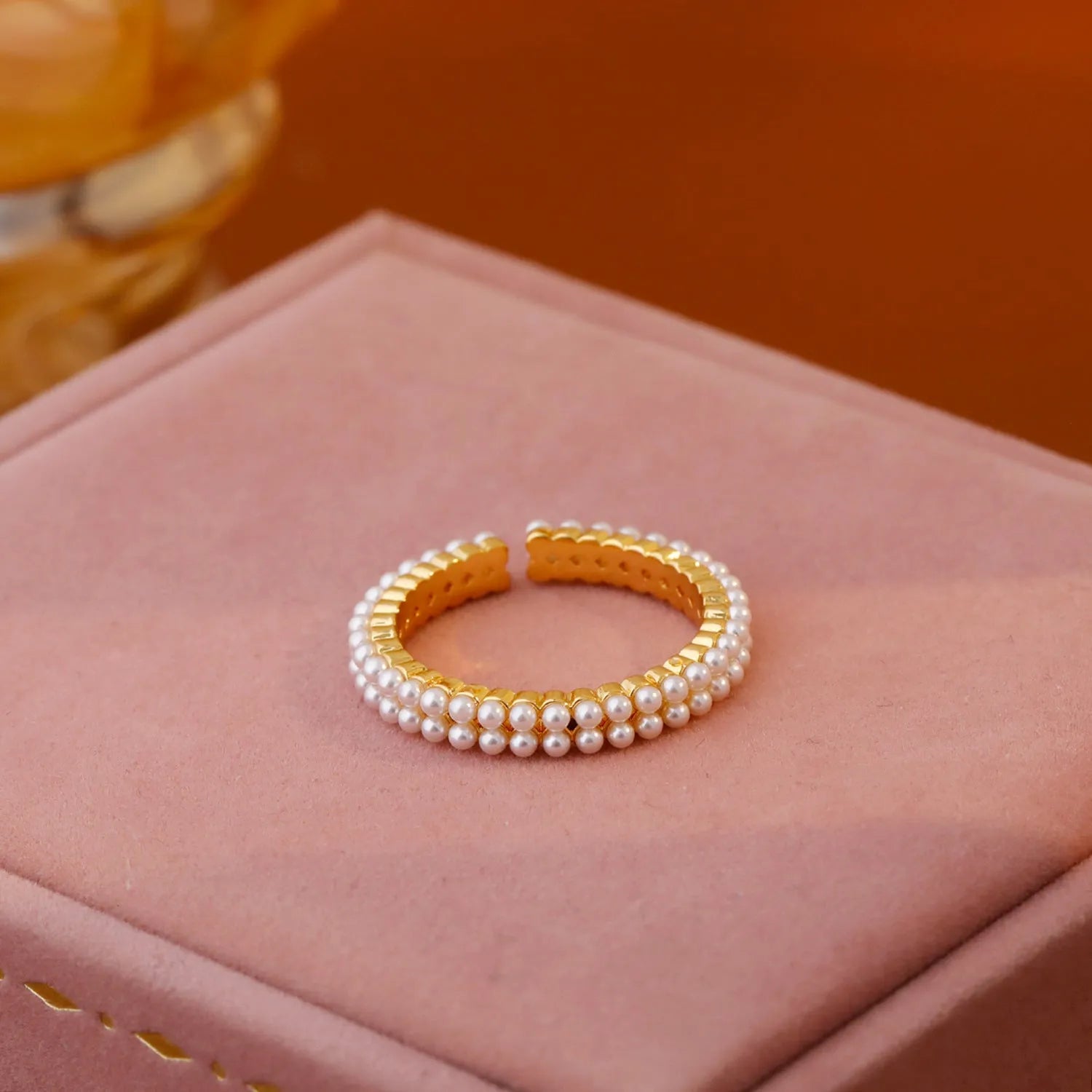 Gold geometric open mouth women's ring with round pearl-like elements on copper base