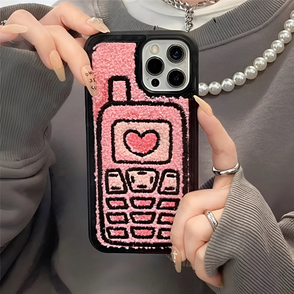 Pink TPU iPhone case with a textured towel-embroidered back cover, shown fitting an iPhone.