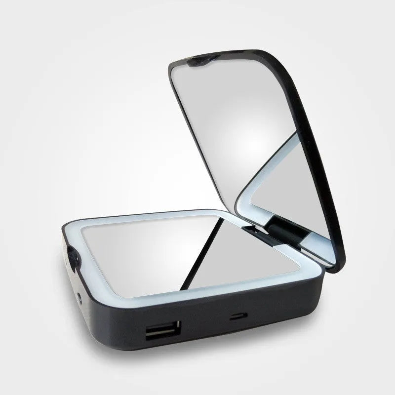 Black and white lighted makeup mirror showing 4x magnifying section and adjustable warm and cool lights.