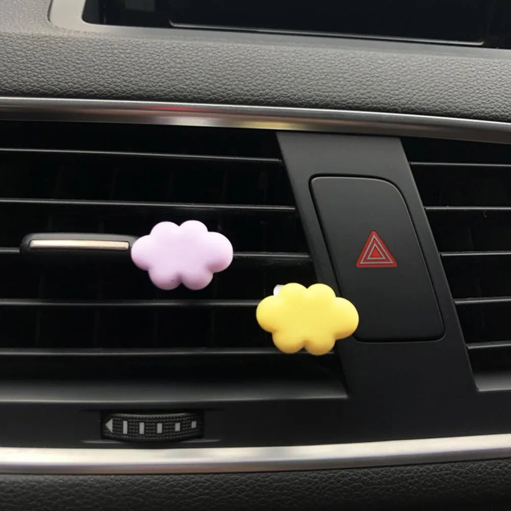 Resin Baiyun cartoon car fragrance clip in multiple colours attached to vehicle air vent measuring 17mm x 27mm