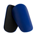 Pair of PU mini shin guards in black with adjustable straps, shown on a leg.