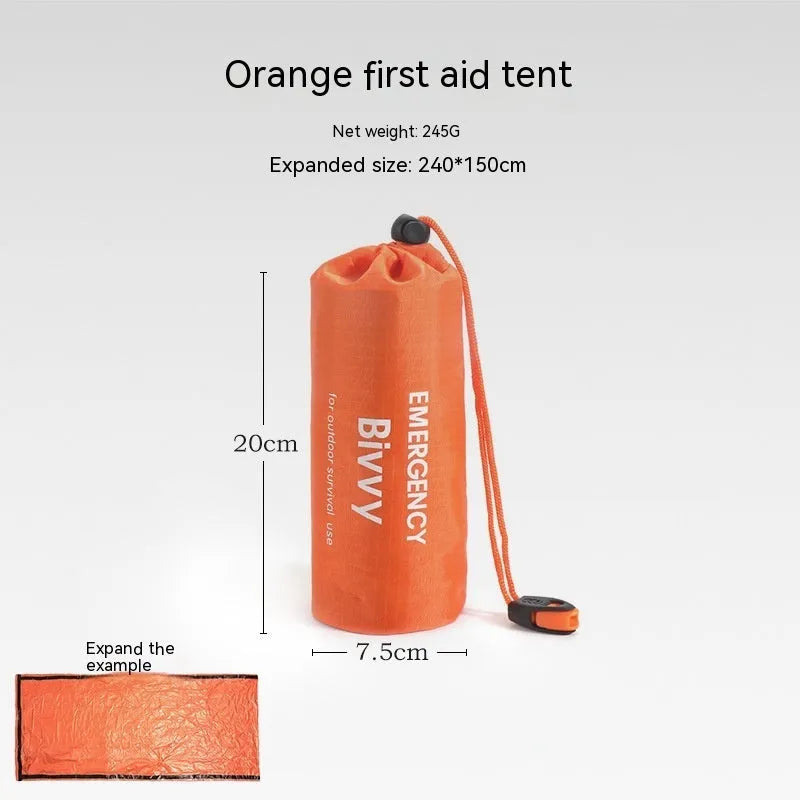 Portable orange disaster relief tent with sleeping bag and emergency blanket setup outdoors