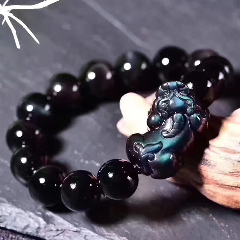 Natural ice colour eye obsidian crystal bracelet showing polished beads with characteristic banding patterns