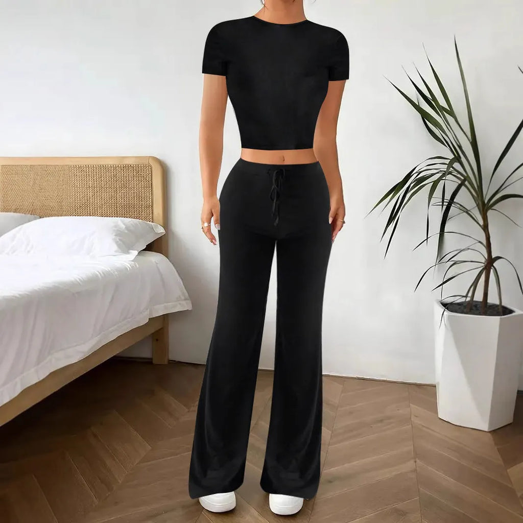 Black women's high waist trousers and short sleeve t-shirt co-ord set on a hanger.