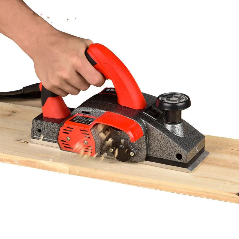 Red desktop electric wood planer with aluminium shell and 82mm planing width
