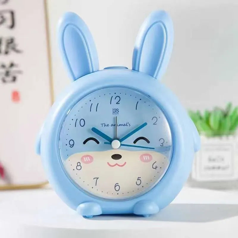 Cartoon children's alarm clock in pink or blue with night light and singing alarm.