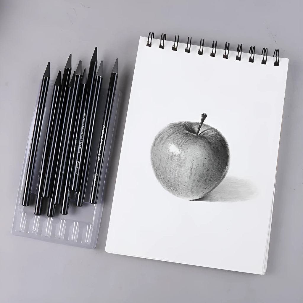 Set of nine wooden drawing pencils on a suction card, containing six graphite and three carbonized pencils for artist sketching.