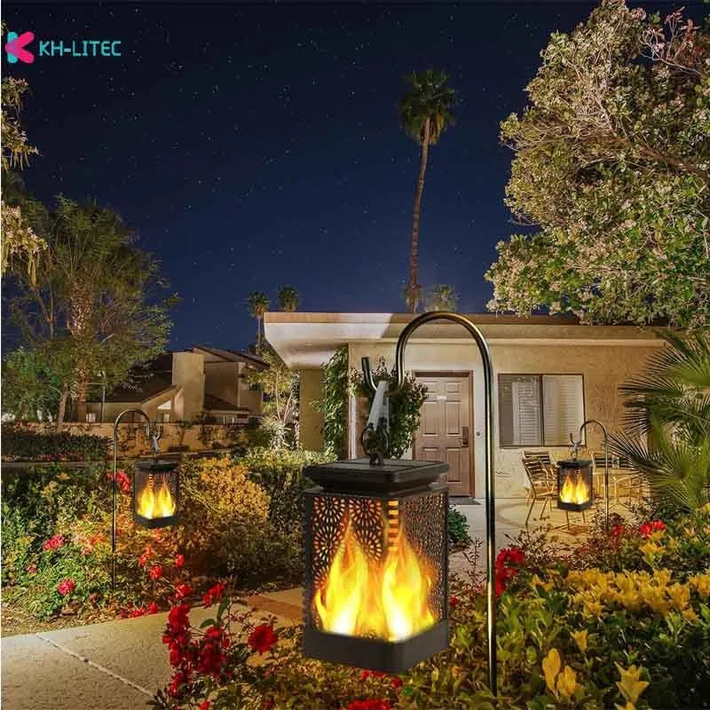 Four black solar-powered hanging torch lights with flickering flame LED effect for garden decoration